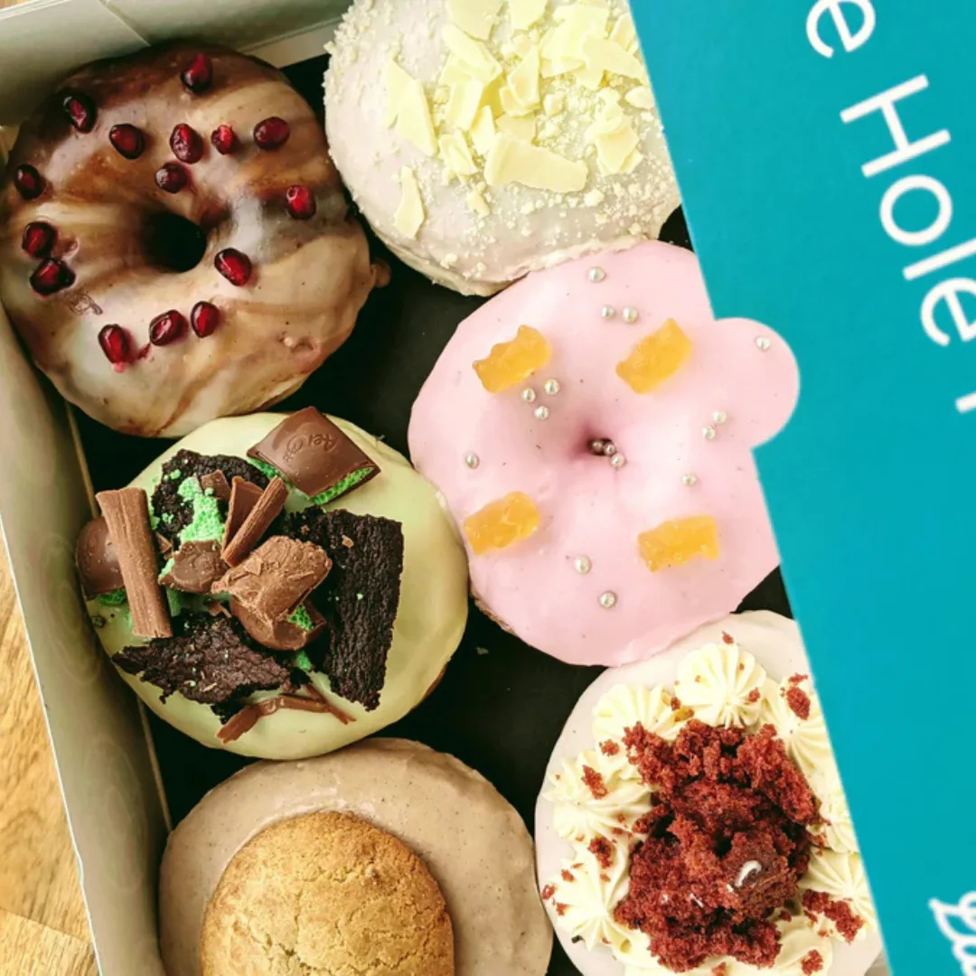 Six_D4H Six decorated donuts in a teal box.